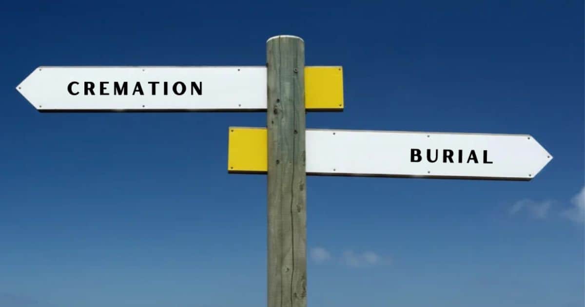 Cremation or Burial signs pointing in opposite directions with blue sky background
