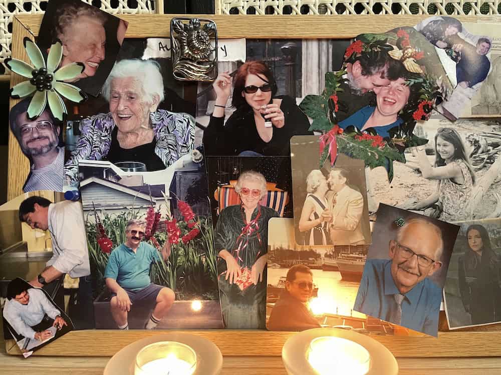 Memory board with lost loved ones with photos and candles.